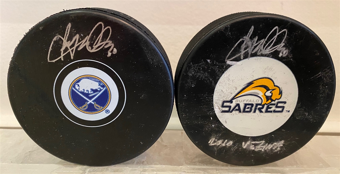 Lot of 2 Ryan Miller Signed Buffalo Sabres Pucks with 2010 Vezina Note (Flawed)